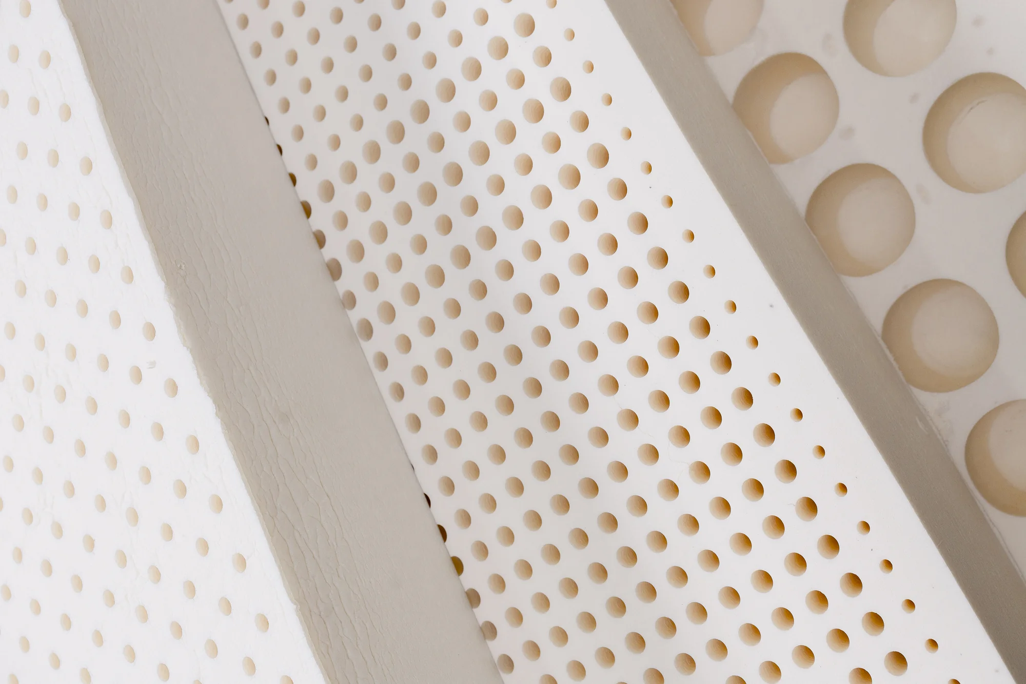 Close-up of natural latex material with rows of pinholes