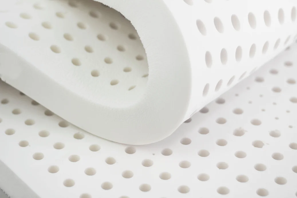 Folded natural latex sheets showing smooth, plain cream material