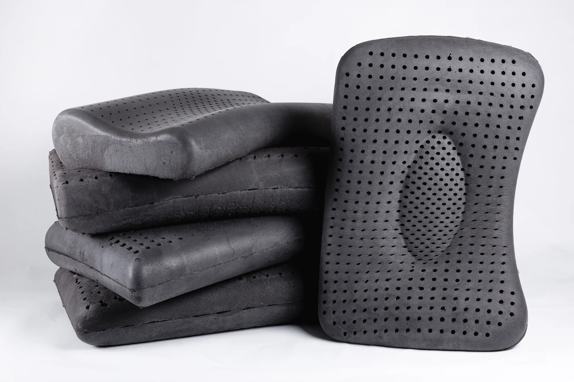 Stack of graphite-infused latex pillows in a charcoal color