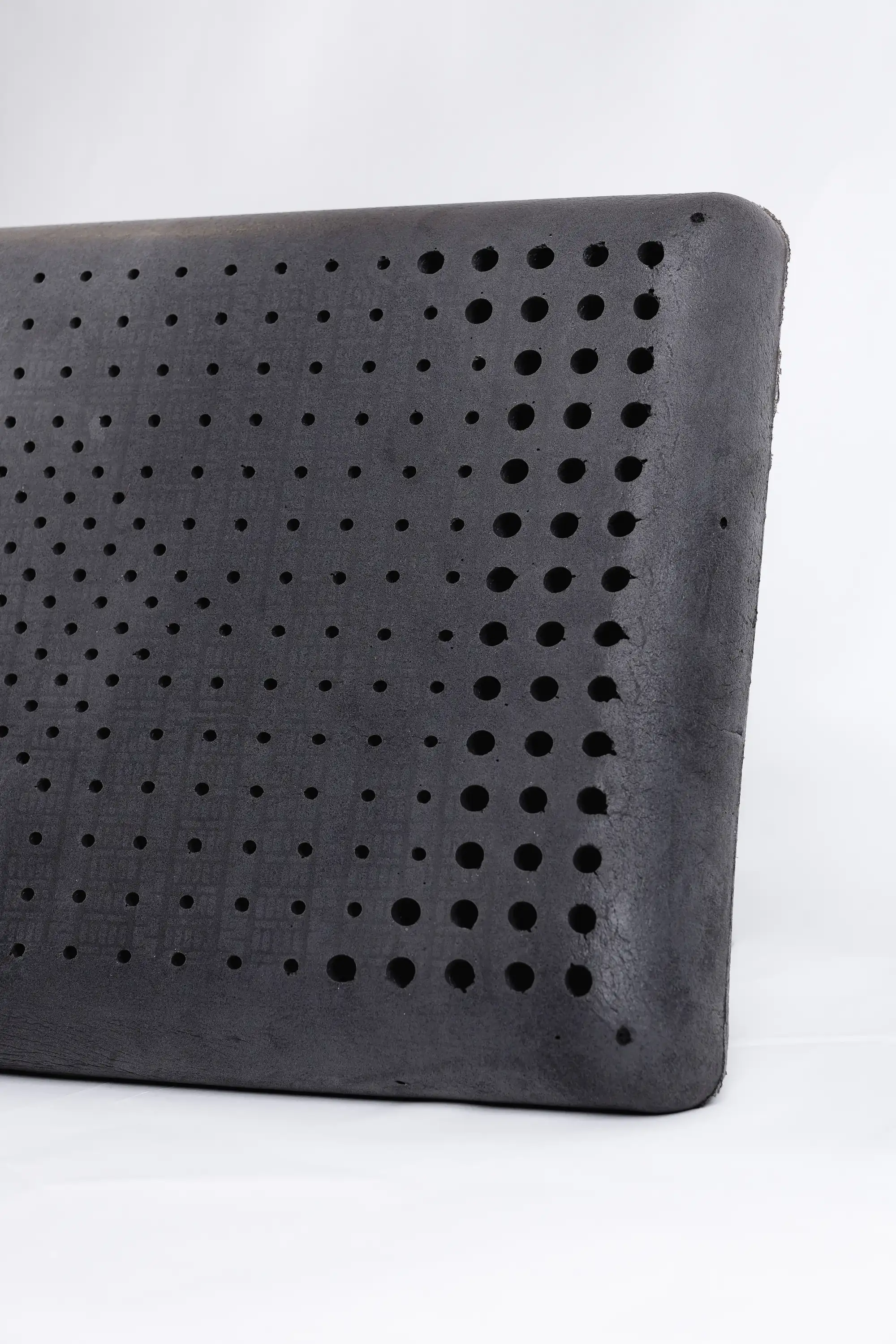 Graphite-infused latex pillow shown at an angle with its dark charcoal color