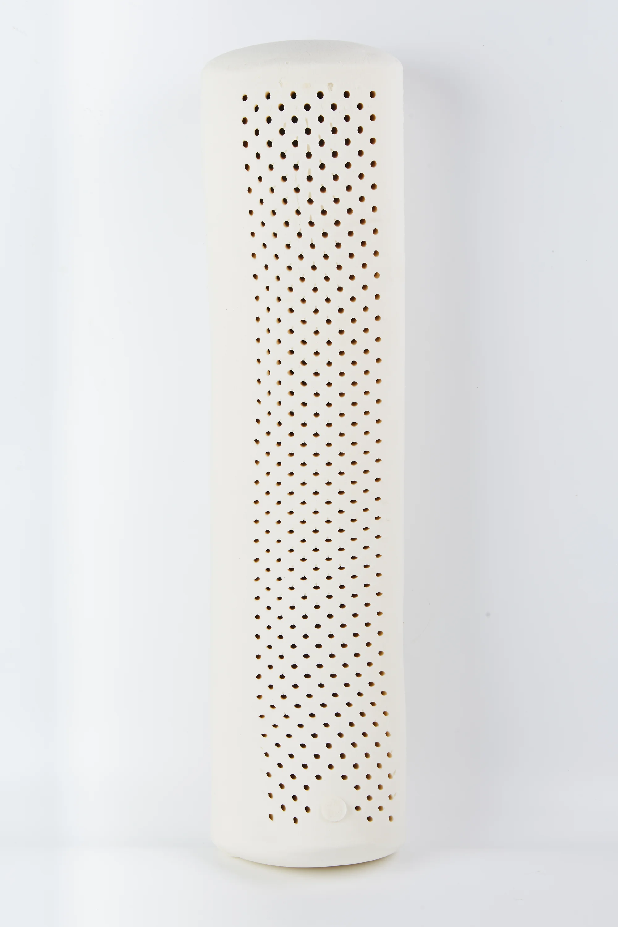 Natural latex bolster pillow shown in a cylindrical shape