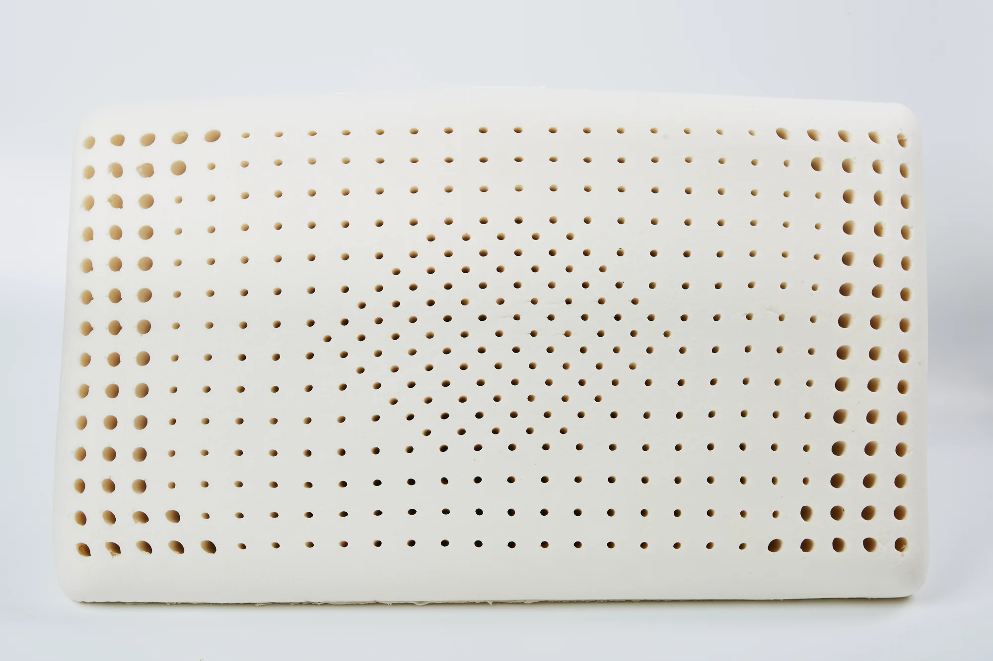 Natural latex pillow shown from a dramatic angle highlighting its texture
