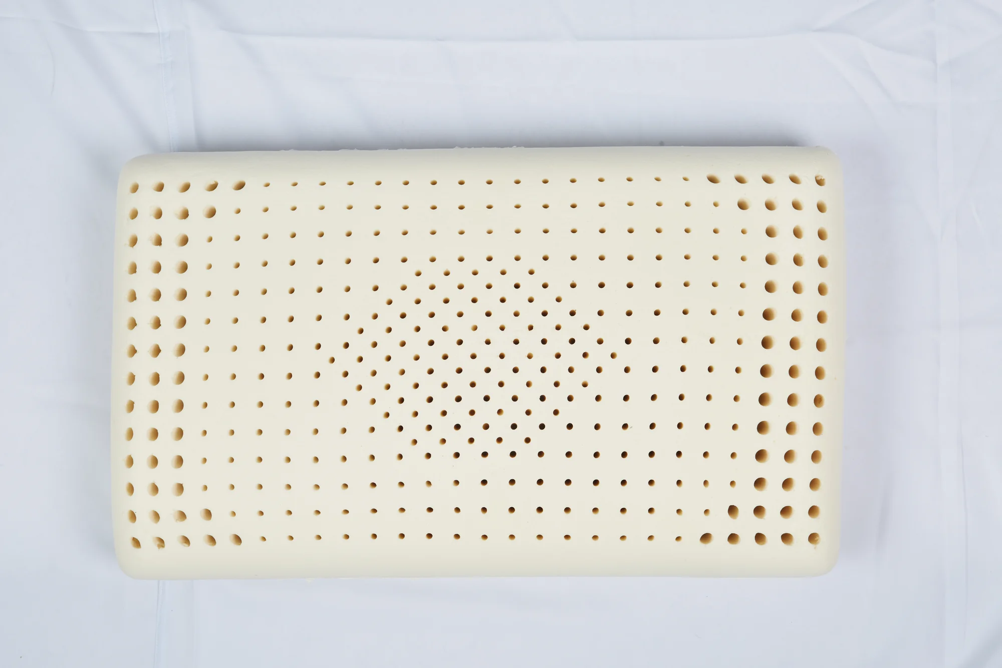 Natural latex pillow with a classic rectangular shape and perforated surface